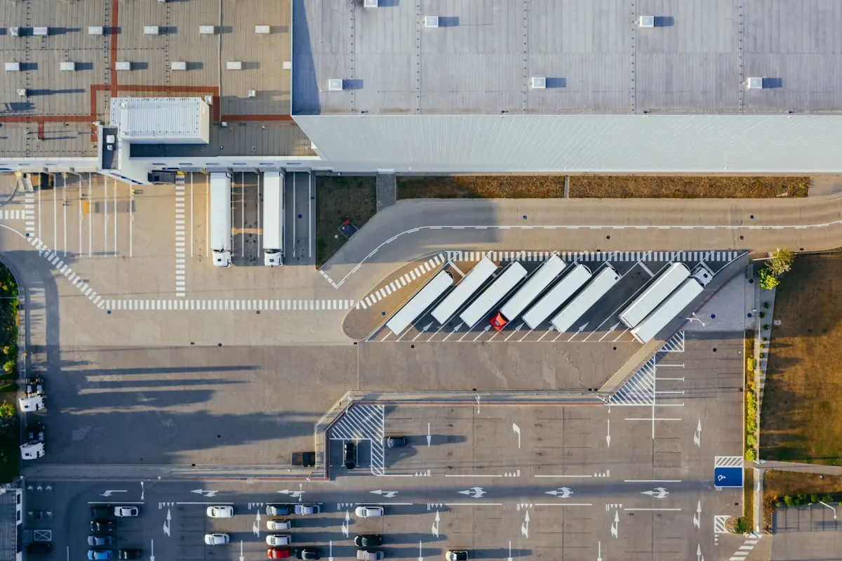 Trucks docked at a distribution center receiving bay, seen from above